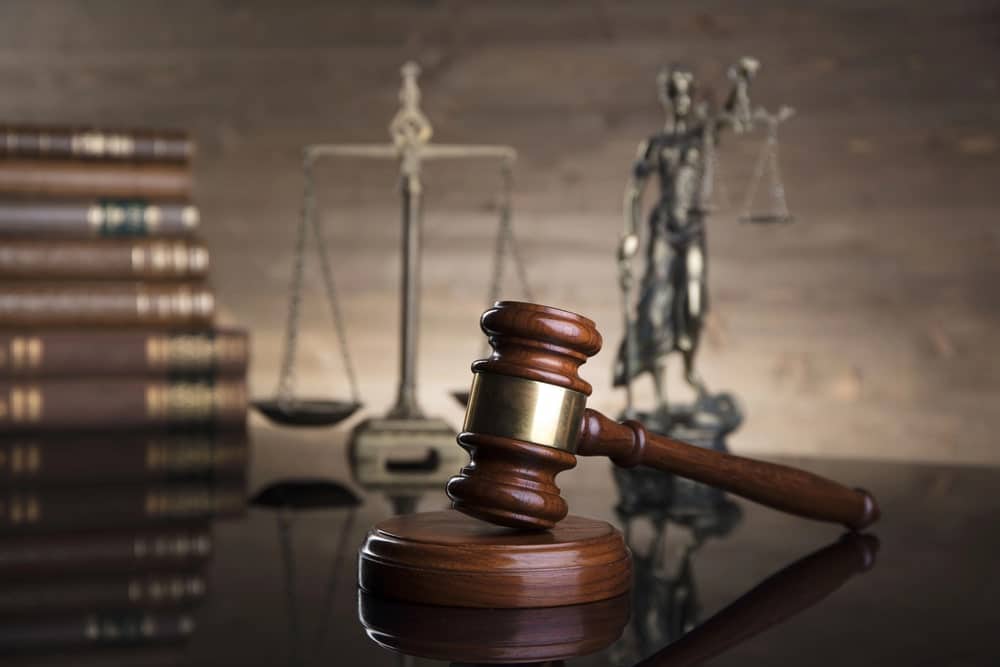 Embezzlement Defence Lawyers in Ottawa Ontario portrayed by gavel and scales of justice next to legal textbooks.